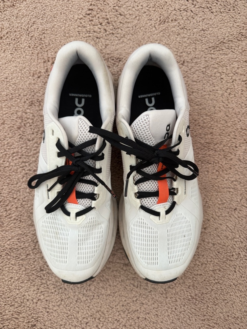 On Running White Sneakers with Black Laces and Orange Tongue Stripe